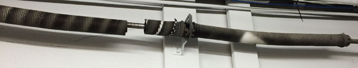 Garage rollup door torsion spring repair